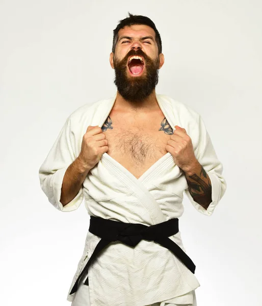 Karate man with angry face in uniform. Oriental sports concept.