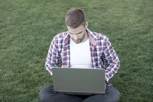 Millennial create business. Modern business. Modern technologies. Student studying on meadow. Online communications. Surfing internet. Man looking laptop screen. Talented developer. Business startup — Stock Photo, Image