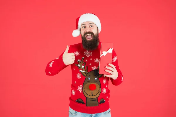 What a great surprise. winter holiday preparations. best present shopping sale. happy new year. merry christmas. cheerful bearded man in santa hat and sweater. brutal hipster celebrate xmas party — Stock Photo, Image