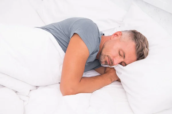 Ontspannen man. Preventie en behandeling van slaapstoornissen bevorderen. Wereld slaapdag. Voordelen van een goede en gezonde slaap. Adem rustig in, slaap lekker. Knappe man in bed. Slapende man thuis. — Stockfoto