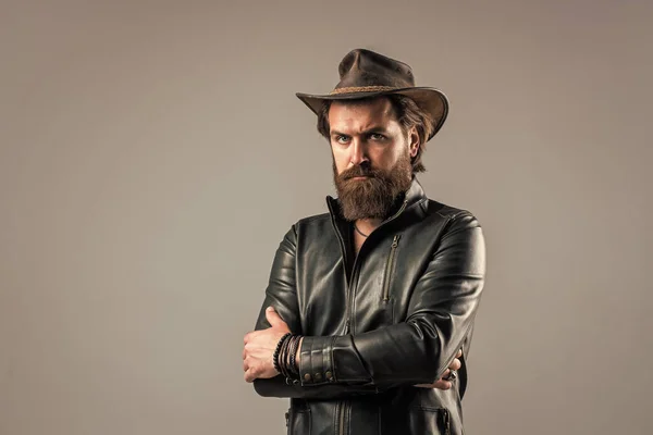 Brutal man cowboy hat leather jacket, confident person concept