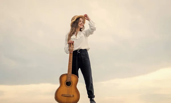 relax with favorite music. musical shop. happy girl enjoy the moment. Have Fun on Celebration. kid singing with guitar. teen hipster playing on guitar. singer with acoustic guitar. music and art