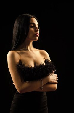 Gerçek bir kadın için güzellik salonu. Siyah elbiseli genç bir kadının portresi. Özel durumlar için elbise giyiyor. Çekici ve çekici bir kız. Kız siyah arka plan. Zarif seksi kadın. Kara Cuma reklamı