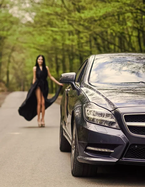 Symbol of richness. Travel by car. Auto service. Rich people lifestyle. Start journey. Luxury car. Auto and pretty sexy woman at road. Travel concept. Traveling and vacation. Transport concept — Stock Photo, Image