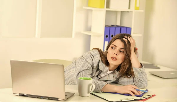 Technology always helps her at work. stylish woman work on notebook. girl follow dress code. tired businesswoman with laptop. elegant woman with document folder. online office worker