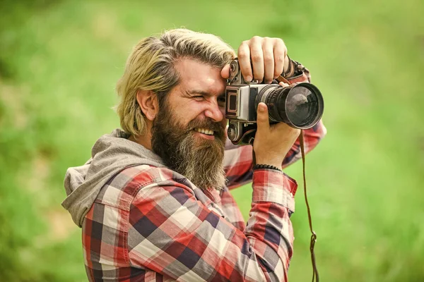Enjoying hot day. bearded man hipster take photo. photo shooting outdoor. brutal man traveler with retro camera. photography in modern life. travel tips. professional photographer use vintage camera — Stock Photo, Image