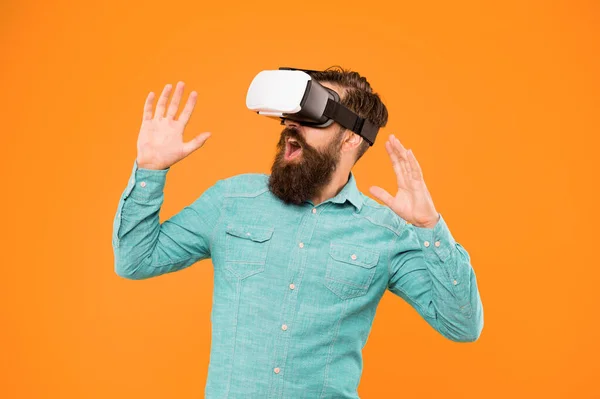 The game is on. Hipster play video game. Bearded man explore VR yellow background. Game developer or gamer. Be part of game with new virtual reality system. Gaming and entertainment