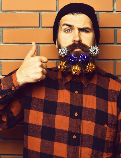 Bearded man, brutal caucasian squinting hipster with gift decorative stars