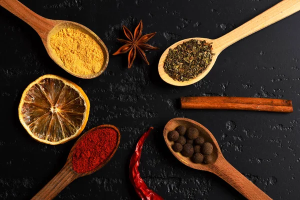 Set of spices on dark grey wood background. Food art — Stock Photo, Image