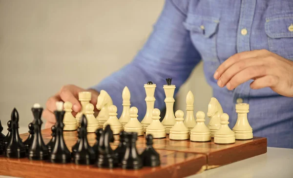 Chess Set. thinking of next move. man training for chess competition. chess figures on wooden board. Focused man playing. thinking of attacking and capturing opponent chess pieces