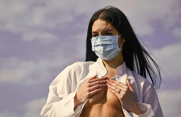 Plastische chirurgie. siliconen implantaat in borsten. medische zorg. sexy dokter. vrouw verpleegster met masker bedekken kale borst. borstkankerconcept. uitbraak van een coronavirus pandemie. Bescherm jezelf. — Stockfoto