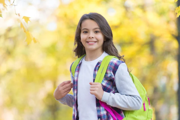 평상복을 입은 행복 한 아이는 가을 숲을 걷고 좋은 날씨에 배낭을 메고 학교 생활을 즐긴다 — 스톡 사진