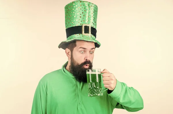 Irish beer pub. Celebration irish culture. Man bearded hipster hat patricks day drink pint beer. Saint patricks day holiday. Cheers concept. Colored patricks beverage. Green color part of celebration