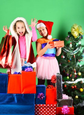 Noel şapkalı çocuklar hediye çantalarını açarlar..