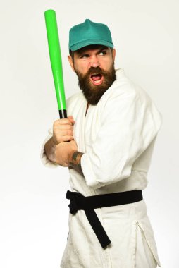 Aç gözlü karateci yeşil beyzbol sopasını tutuyor..