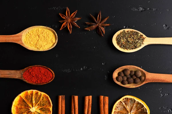 Composition of condiment, top view. Wooden spoons with spices