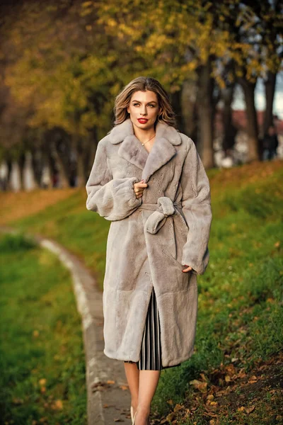 foolproof party glamour. lady looking trendy walk in street. comfortable and warm. complement your outfit. modern winter fur coat. elegant woman red lips wear fur coat. best luxury clothing material