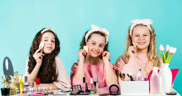 friendship party with cosmetic. relax and having fun. small girls in beauty salon. little sisters in retro fashion headscarf. makeup for kids. group of happy friends at spa. Funny advertising