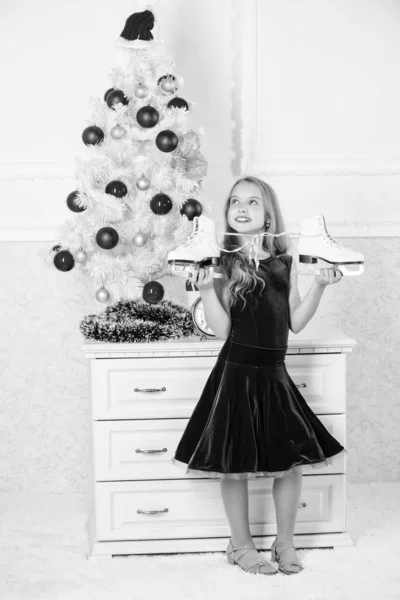 Tenho um presente que ela queria. Conceito de patinagem artística. Kid near christmas tree hold skates gift. Menina satisfeita presente de Natal. O melhor presente de sempre. Feliz ano novo conceito. Os sonhos se tornam realidade — Fotografia de Stock