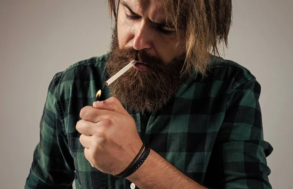 Health safety and addiction. handsome brutal man. bearded man. smoking cigarette habit. brutal hipster with moustache. fashion model wear casual clothes. male beauty standard. looking so trendy