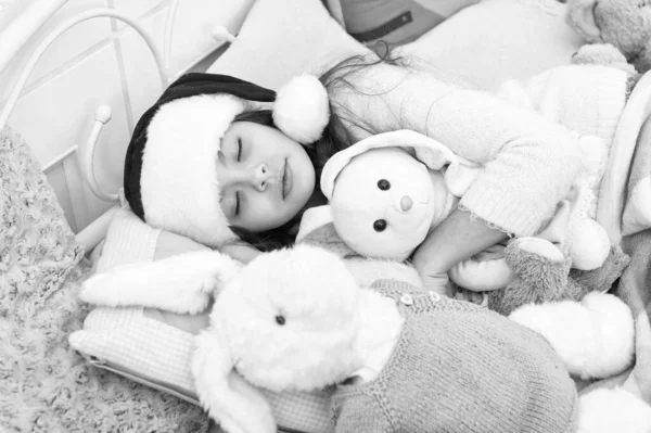 Magical morning. Christmas eve concept. Cozy room. Small child relaxing in bedroom. Kid lay in bed relaxing. Sweet home. Girl little kid relaxing on bed light interior with christmas decorations — Stock Photo, Image