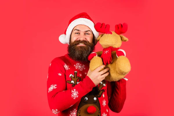 Happy man playful mood. Merry xmas. Happy new year. Oh my deer. Helping Santa Claus. Symbol of Christmas. Christmas eve. Dear Santa. Bearded man reindeer toy. Hipster man hold Christmas gift