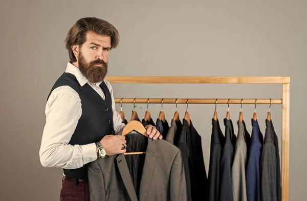 Creating new fashionable styles. Man with suit. tailor in his workshop. Handsome bearded fashion man in classical costume suit. Man in custom tailored suit presenting expensive tailored tuxedo — Stock Photo, Image