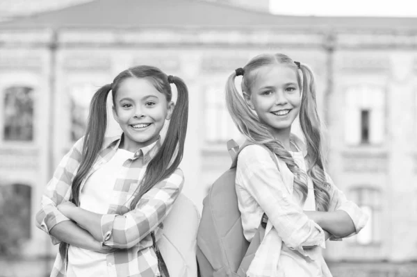 School is for all. Happy girls back to school. Little children carry school bags. School and education. Knowledge day. September 1. Startup. Hand in hand we learn — Stock Photo, Image