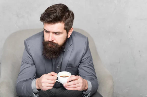 The coffee you can rely on. Businessman drinking coffee in the morning. Bearded man enjoying his coffee break. Hipster holding coffee cup, copy space