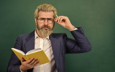Uygun kurslar seçiliyor. Kitabı olan öğretmen konuyu açıklar. Kara tahtanın önündeki adam. Üniversite ve lise. Edebiyat konusu. Kitap okuyorum. Ders kitabı olan bir öğretmen. Tecrübeli öğretmen.