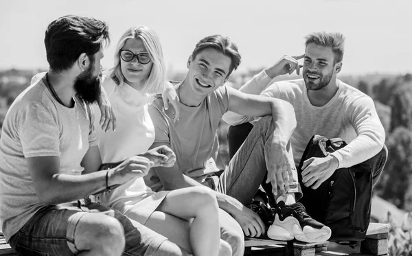 We are family. happy men and girl relax. Group of people in casual wear. best friends. Summer vacation. diverse young people talking together. group of four people. great fit for day off