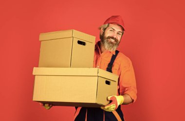Life Just Got Better. purchase of new habitation or repair of room. Man wearing boilersuit packing boxes. move to new apartment. bearded loader in uniform. Cardboard boxes - moving to a new house clipart
