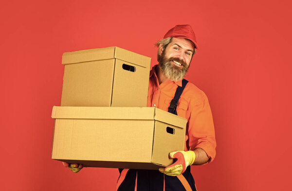 Life Just Got Better. purchase of new habitation or repair of room. Man wearing boilersuit packing boxes. move to new apartment. bearded loader in uniform. Cardboard boxes - moving to a new house