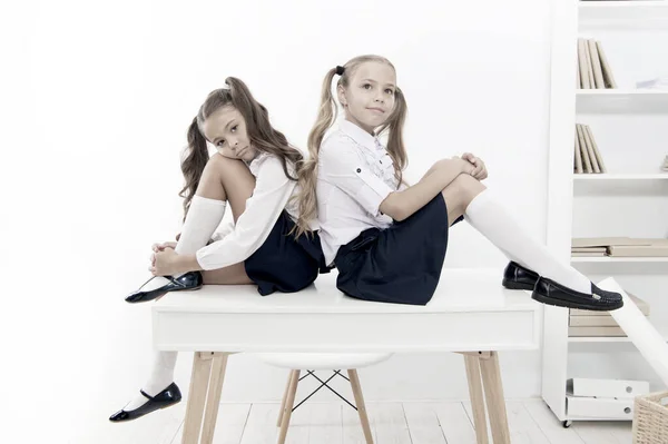 Informal and formal knowledge. Cute little schoolgirls having lesson on Knowledge day. Small children celebrating day of knowledge on September 1. Getting knowledge and skills at school