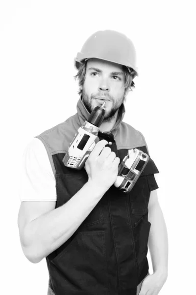 Obrero con taladro inalámbrico en la mano y expresión facial reflexiva — Foto de Stock