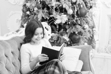 Kış tatilinde okunacak kitap. Mutlu kitap okuyucular. Küçük çocuk Noel kitabını okudu. Küçük kız yeni yıl arifesinde okumayı sever. Tatil kitapları satışı. Kütüphane. Bibliopol. Günde bir sayfa.