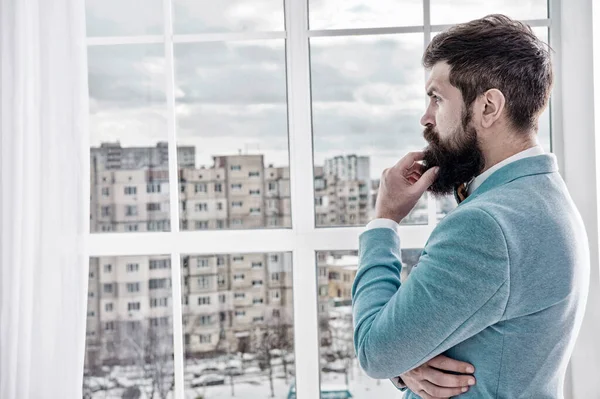 Life choices and expectations. Right decision. Wedding morning concept. Wedding day. Groom bearded hipster mature man wear light blue tuxedo and bow tie. Man stand at window nervous about wedding — Stock Photo, Image