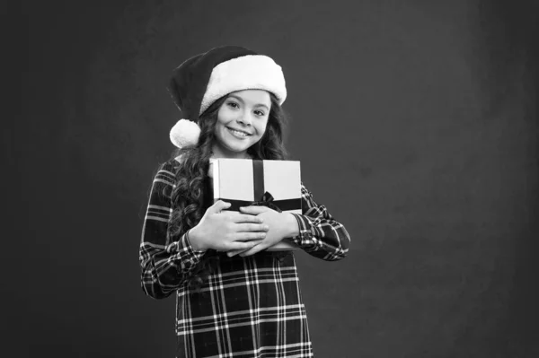 С зимними праздниками. Маленькая девочка. Подарок на Рождество. Детство. Маленькая девочка в красной шляпе Санты. Новогодняя вечеринка. Малыш Санта Клауса. Рождественские покупки. Торговый центр — стоковое фото