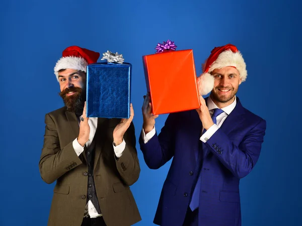 Empresarios con caras alegres sostienen cajas de regalo rojas y azules. —  Fotos de Stock