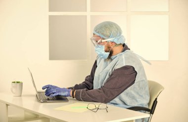 Coronavirus salgını hakkında bilgi toplayın. Kendini karantinaya almış bir adam. Koruyucu maskeyle evde kal. Dezenfektan jeliyle ellerini temizliyor. Virüslerden uzak dur. Evde Sosyal Medya Etkisi