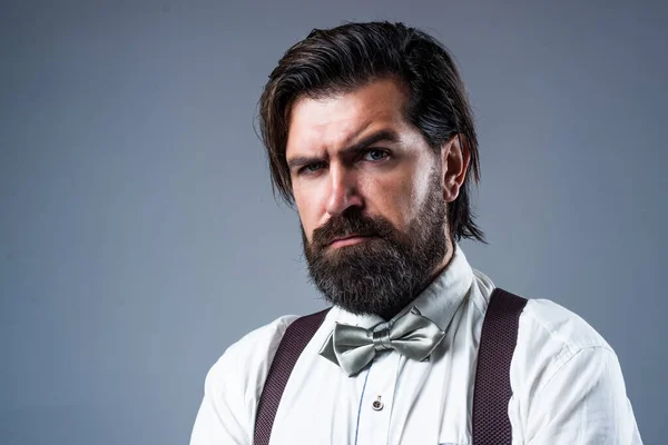 real gentleman. trendy man in suspenders and bow tie. confident and elegant man in classical wear. masculinity and charisma. formal party dress code. old fashioned bearded hipster