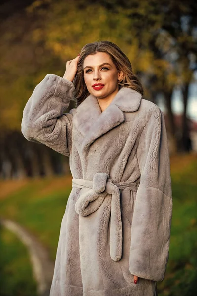 Fur boutique. Simple and warm. Glamorous lady. Cosy autumn outfit. Winter fashion trends. Luxury segment brand. Soft jacket furry texture. Sexy woman red lips wear fur coat. Businesswoman in fur coat