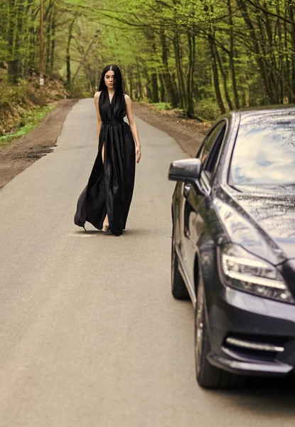 Rich people lifestyle. Start journey. Luxury car. Auto and pretty sexy woman at road. Travel concept. Traveling and vacation. Transport concept. Travel by car. Auto service. Status and respect