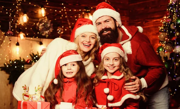 Happy holidays. Family tradition. Parents and children excited about christmas. Bearded man and mother with cute daughters christmas eve. Spend time with your family. Friendly family winter vacation