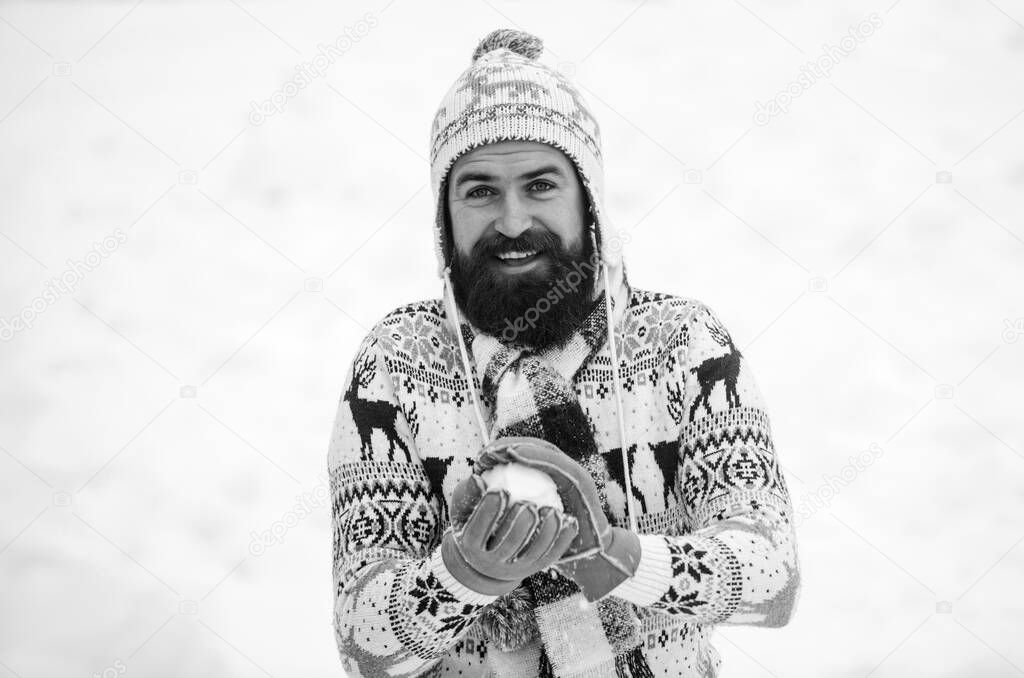 Holyday atmosphere. happy hipster play snowballs. man having fun outdoor. winter season. Christmas snow activity. winter holiday. Morning before xmas. bearded man in warm clothes. Happy new year