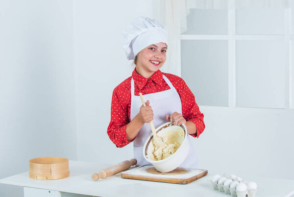just perfect. girl making dough from flour and eggs. dieting and health. culinary school. traditional cuisine. kid having fun with food at kitchen. Child and baking. Healthy eating and lifestyle