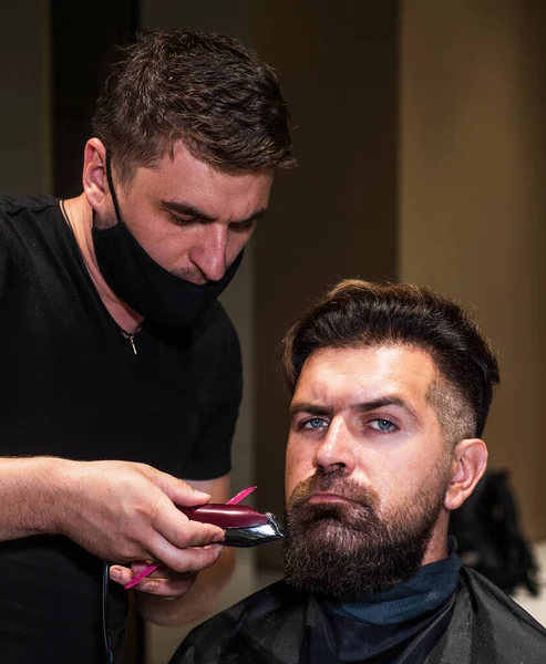 Beard grooming. perfect haircut with blade razor. barber master cut hair. mature hipster with beard at hairdresser. brutal hipster with moustache making new hairstyle. barbershop. male trendy hairdo
