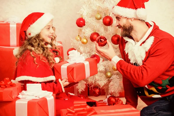 Christmas family holiday. Christmas gift for child. Make your childs holiday extra special this year. Father christmas concept. Dad in santa costume give gift to daughter cute kid. Happy childhood