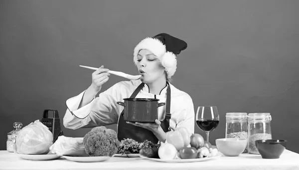 Easy ideas for christmas party. Healthy christmas holiday recipes. Woman chef santa hat cooking hold wooden spoons. Best christmas recipes. Christmas dinner idea. Cooking for family. Try main meal