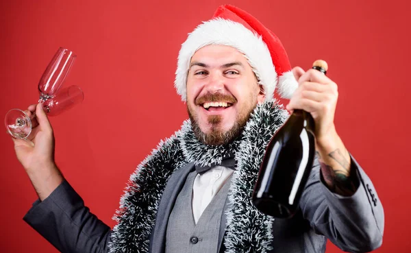 happy time. winter holidays. happy man celebrating xmas. corporate new year party. businessman in santa hat with tinsel. christmas time for fun. man business suit drink champagne from glasses. cheers